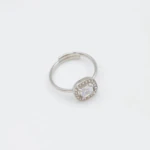 Bague femme argentée ajustable à pierre carrée brillante entourée de petits strass, sur fond blanc