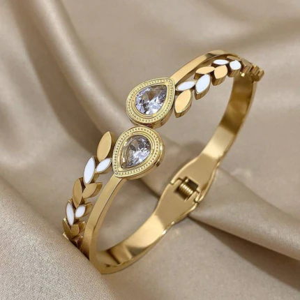 Bracelet jonc doré femme à feuilles blanches et deux gouttes de cristal transparent sur satin beige