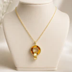 Collier pendentif cercle effet écaille brun ambré et anneau doré sur buste de présentation