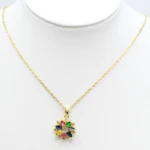 Collier chaîne fine dorée à pendentif fleur multicolore présenté sur un buste blanc