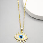 Collier doré femme pendentif œil bleu et détails brillants