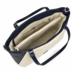 Sac cabas ouvert vu de dessus : doublure beige, compartiment zippé central et poches intérieures
